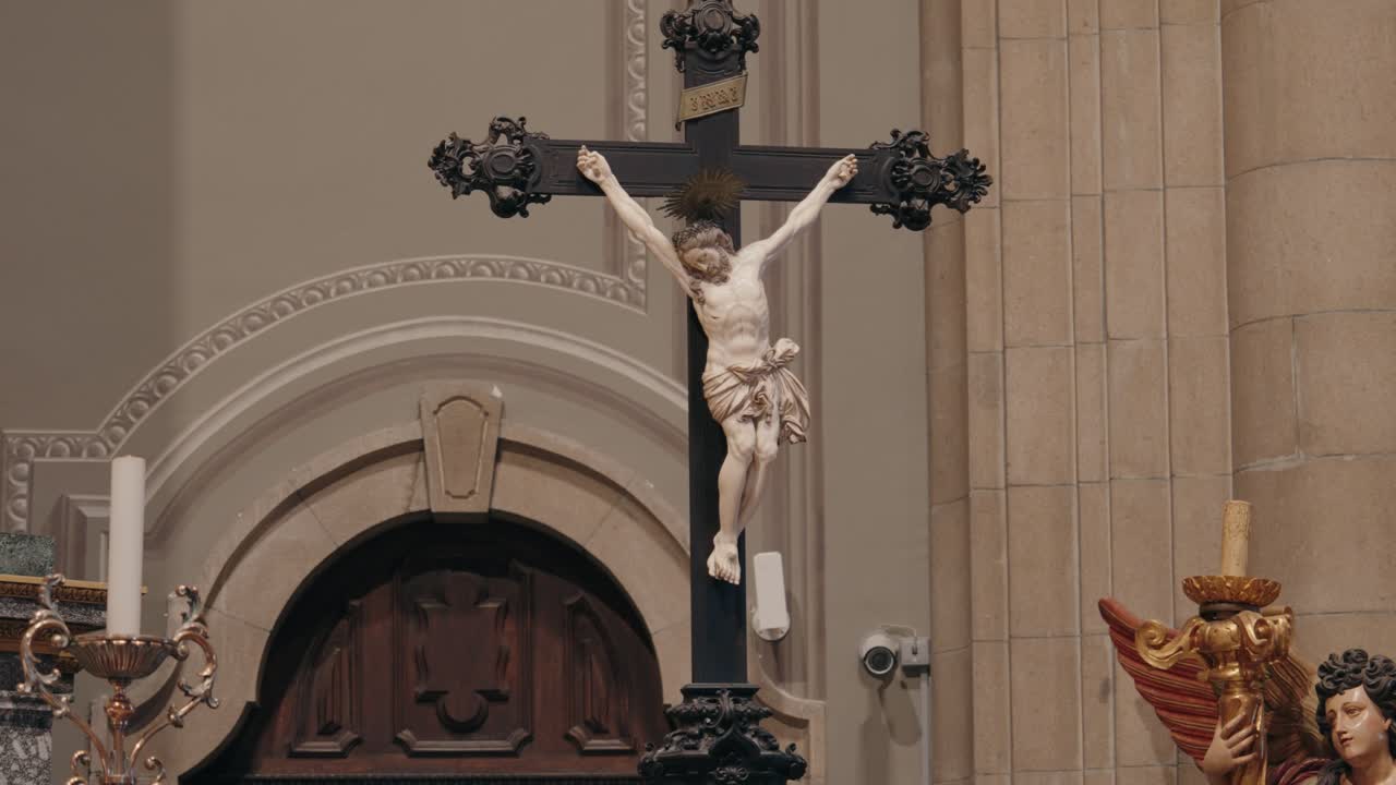Jesus on cross statue above altar in detailed classic stone church