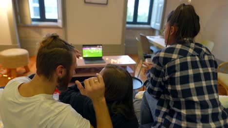 amigos viendo un partido de fútbol en casa