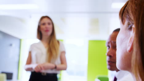 female boss talks to business colleagues at informal meeting