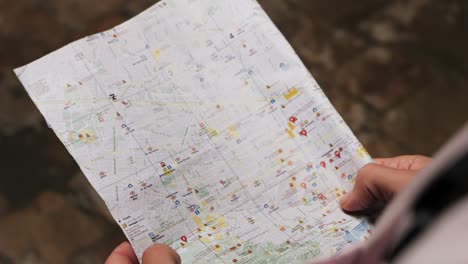 man tourist using smart phone searching location in map application online close up macro. backpacker using gps to find destination on vacation. city or forest hiking, walking in europe
