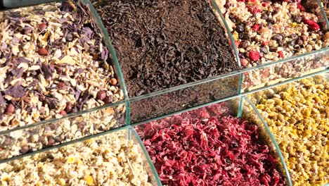 assortment of dried herbs and teas in glass display cases