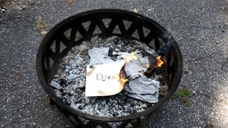 Burning-negative-messages-written-on-paper-in-fire-pit