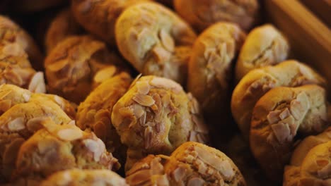 panning out from macro closeup of french almond cookies in wooden box