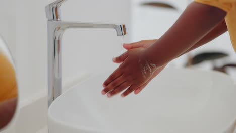 kid, washing hands and water with soap in bathroom