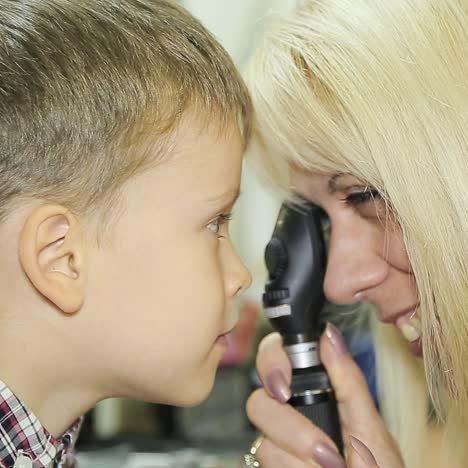 professional ophthalmologist checks the eyesight of the child. eye examination