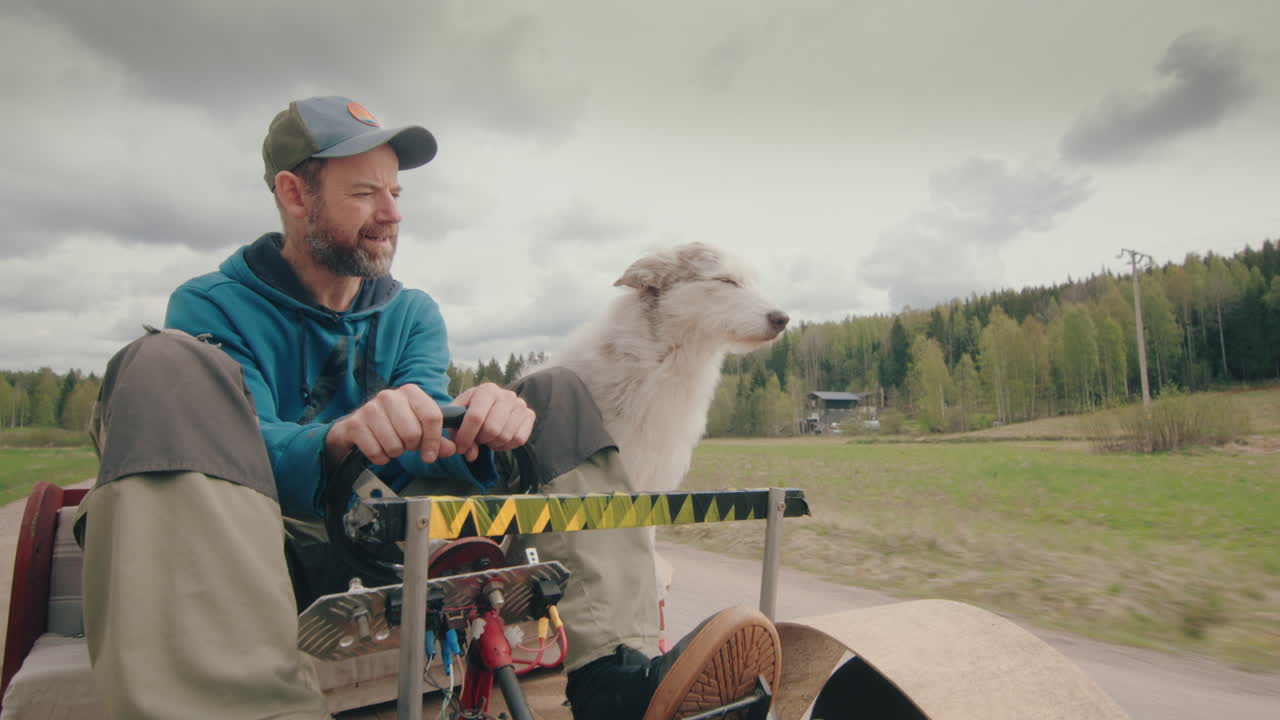Man with funny sidekick companion pet dog drive gokart on country road, POV