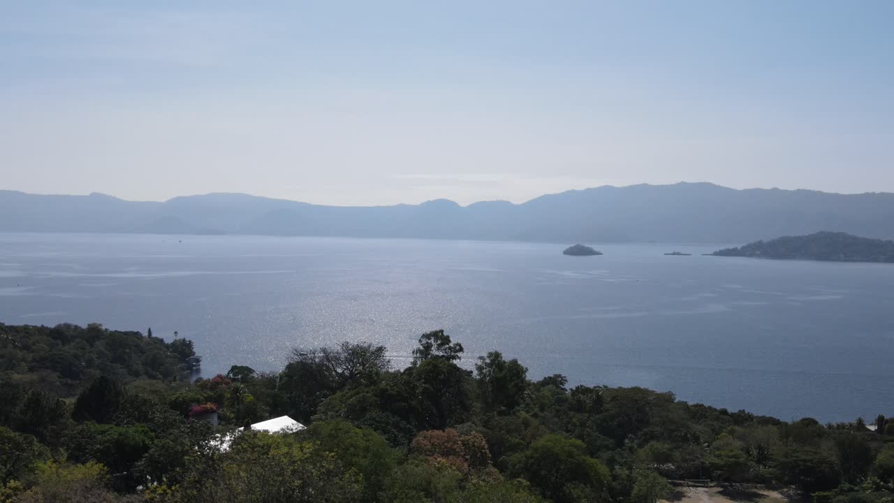 Views of the beautiful Ilopango Lake in El Salvador, with mountains and volcanoes around during the summer
