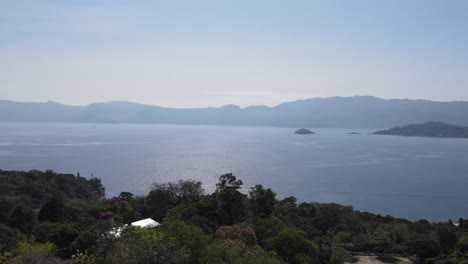 views of the beautiful ilopango lake in el salvador, with mountains and volcanoes around during the summer