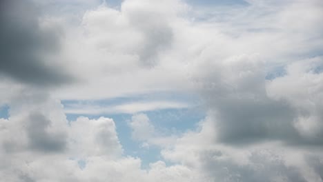 4k timelaps of fluffy cumulus storm clouds sweeping across the blue sky