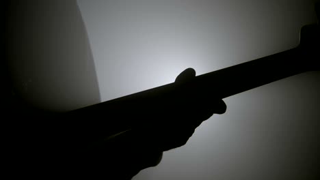 silhouette of a man playing bass