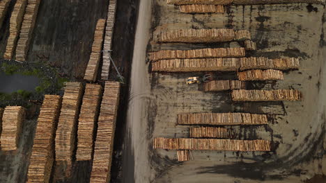 aerial view of stockpile of cut down tree logs in waimahara log wharf in picton, shakespeare bay, new zealand