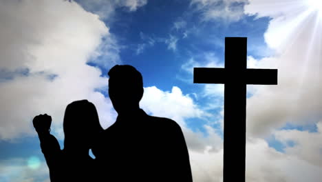 animación de la silueta de la pareja sobre nubes y cruz