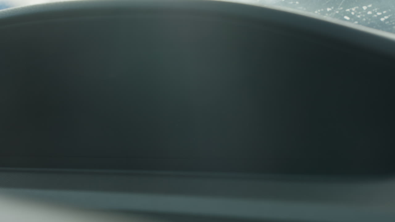 close up digital speedometer on car dashboard showing zero kmh and fuel gauge icon illuminated in amber glow numeric display crisp instrument cluster lights vehicle interior reflecting light glare