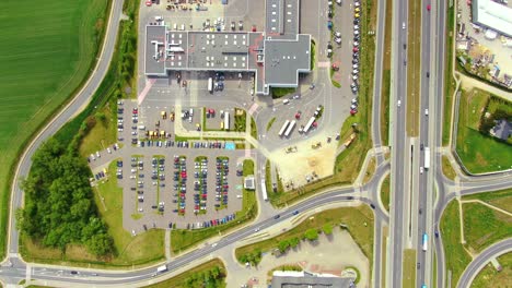 Aerial-top-down-view-of-the-big-logistics-park-with-warehouses,-loading-hub-and-a-lot-of-semi-trucks-with-cargo-trailers-awaiting-for-loading-unloading-goods-on-ramps