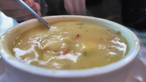 close-up of a creamy bowl of soup being eaten