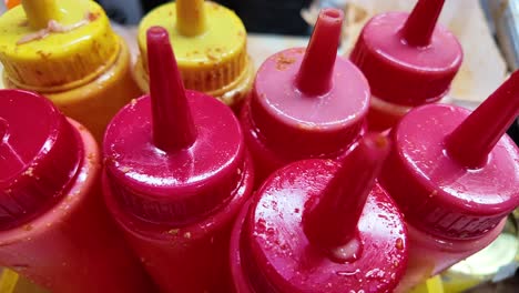 close-up of various sauces in plastic bottles