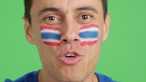 close up of a man supporting thai team