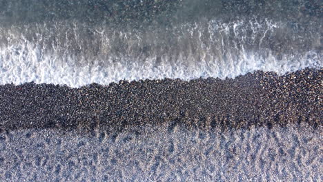 Top-down-View-Of-Pebble-Beach-In-Crete,-Greece---drone-shot