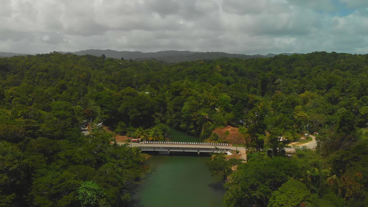Aerial footage of a bridge over a river with a rainforest in the background at this epic northcoast location in Trinidad and Tobago