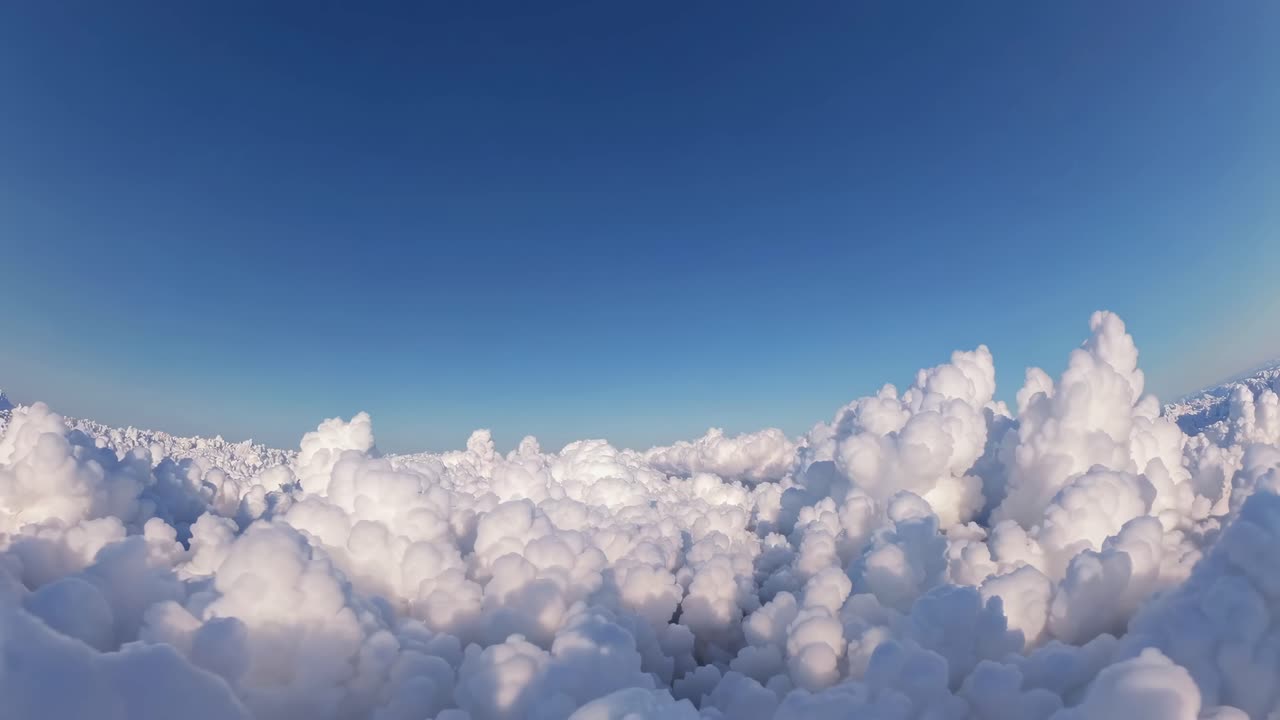 Aerial view of fluffy clouds resembling a serene landscape, captured in a wide-angle shot