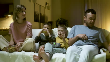 family enjoying movie