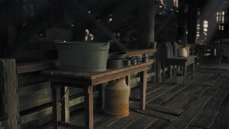 old rustic wooden table with metal bucket and other items