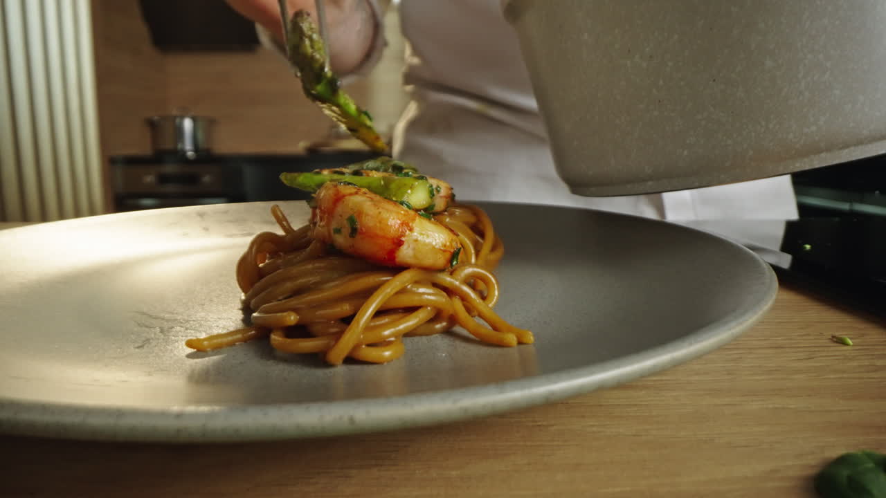 Preparing a gourmet shrimp and asparagus pasta dish