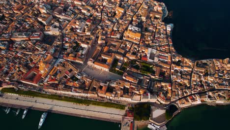 Ortigia's historic old town center with famous buildings. Syracuse, Sicily, Italy top down aerial drone.