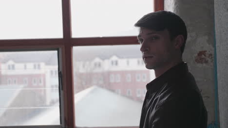 man near window posing attractive look in photographer's studio - medium shot