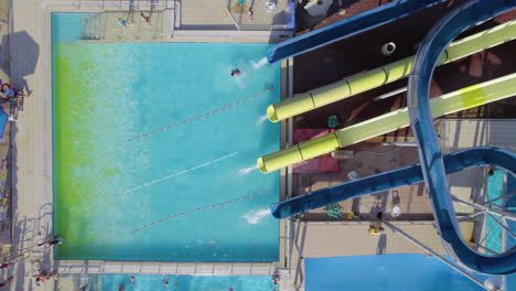 children slide down water slides in a water park attraction