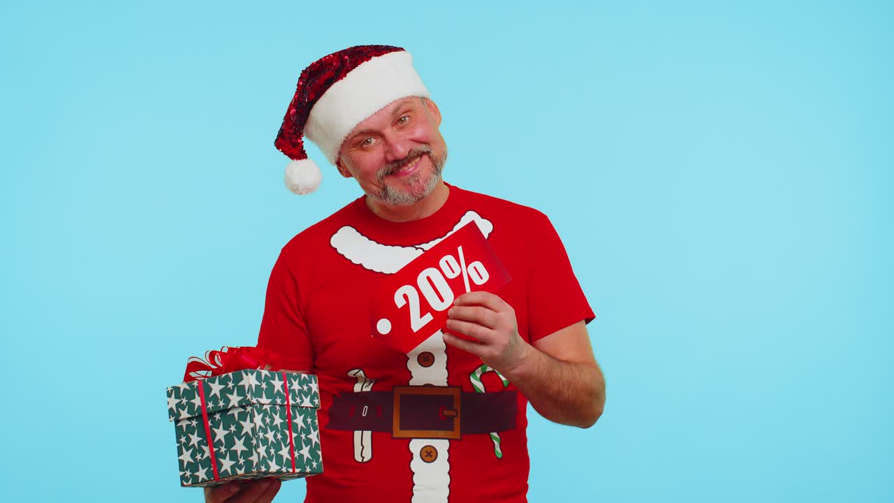 Man in red christmas tshirt showing gift box and 20 percent discount inscriptions banner text note