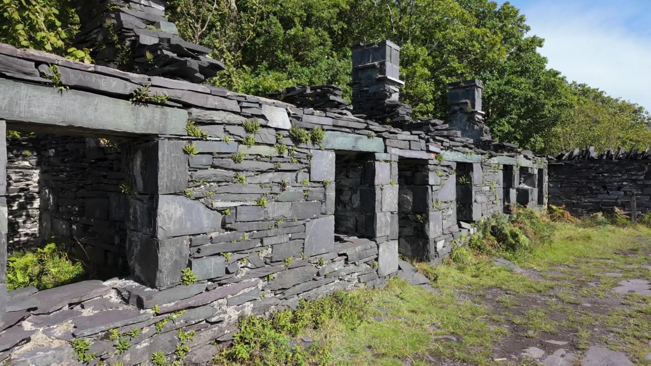Dinorwic slate quarry miners houses abandoned camera panning right to left