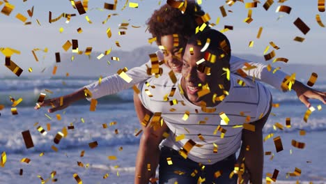 Animation-of-christmas-confetti-over-african-american-man-with-son-on-beach