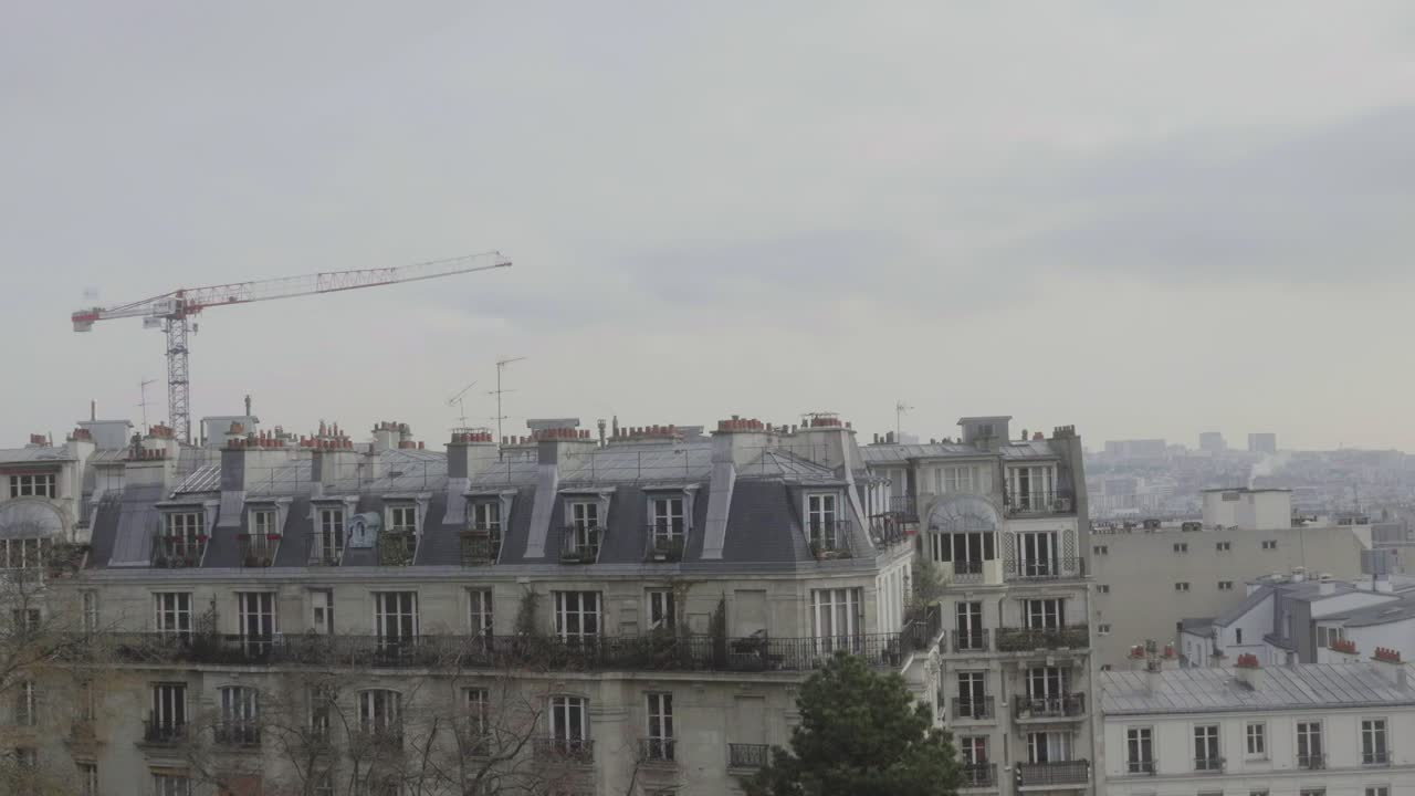 Typical Parisian architecture buildings. Crane on the horizon