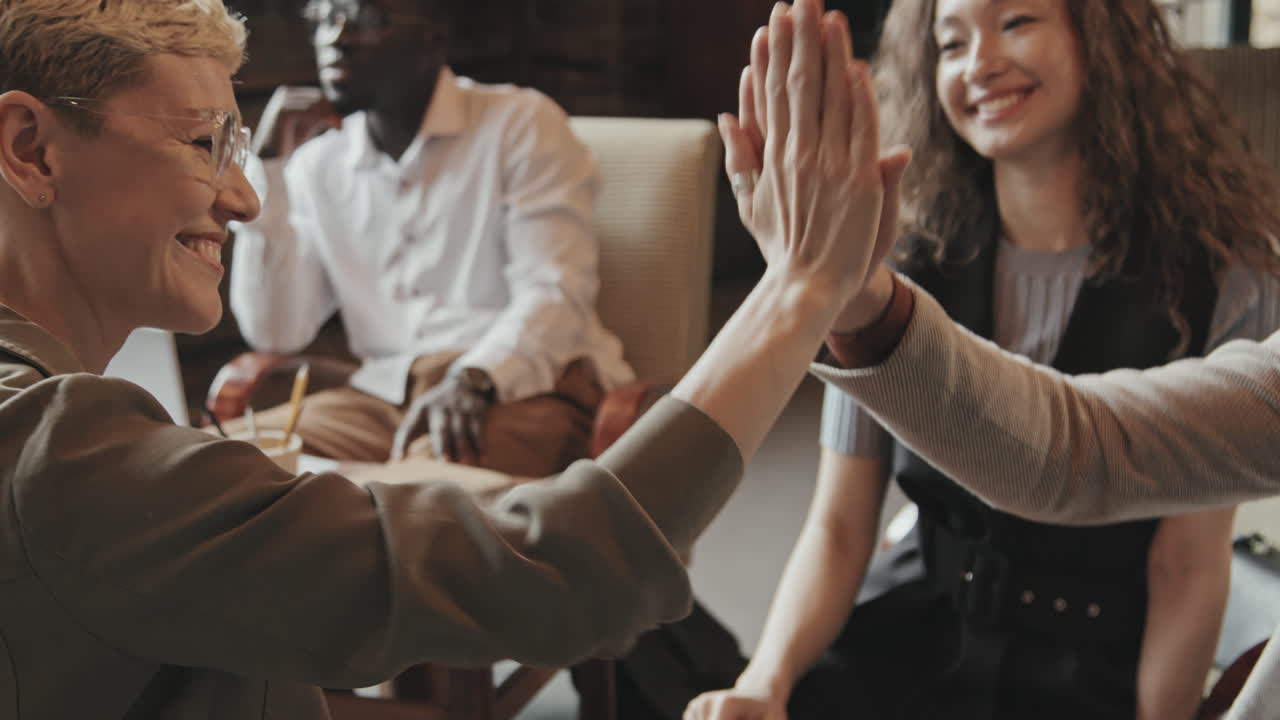 Multi-Ethnic Coworkers Giving High-Fives to Each Other