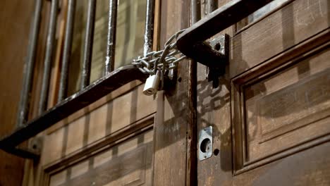 closeup of a locked wooden door at night