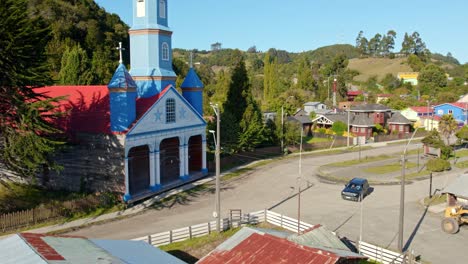 Drone-Flyover-Tenaun-Church,-Historical-Tenaun-Village,-Chiloe-Island,-Chile-4K