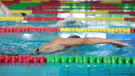 Two-female-and-one-male-swimmer,-during-freestyle-training,-slow-motion