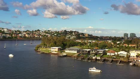 beautiful aerial landscape shot, panning view from bulimba towards hamilton capturing affluent riverside residential neighborhoods in daytime, brisbane city, queensland, australia