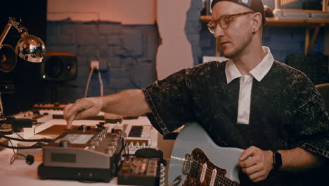 musician playing electric guitar in a recording studio