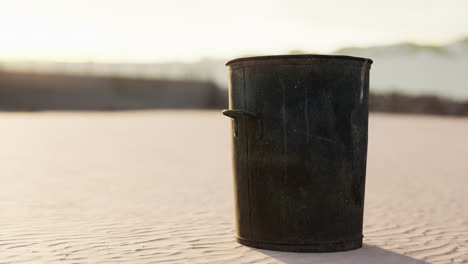 gray metal garbage bin or trash can on the beach