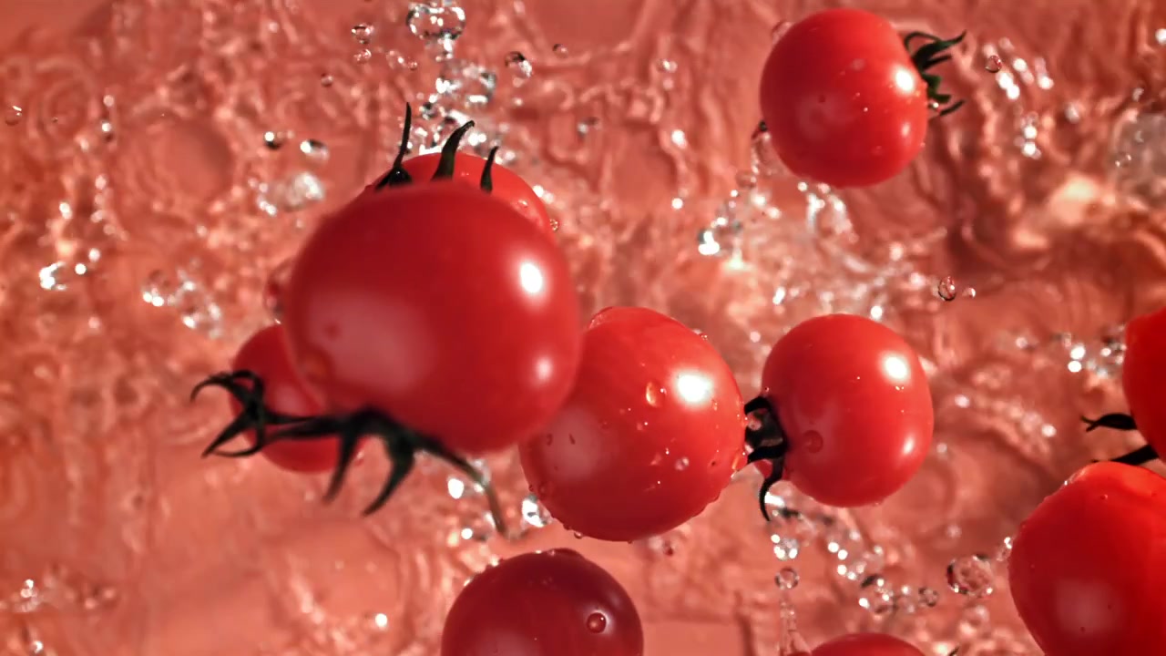 Fresh Cherry Tomatoes Splashing in Water in Slow Motion