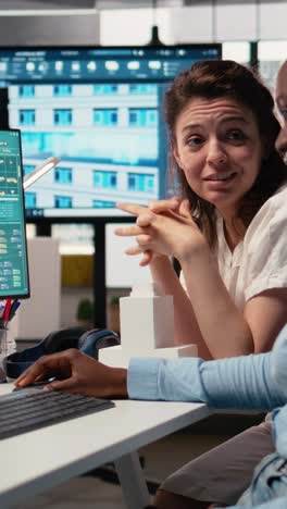 vertical video two developers reviewing blueprints for real estate project planning