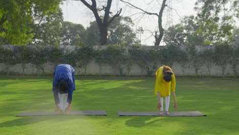 indian couple doing yoga and stretching together