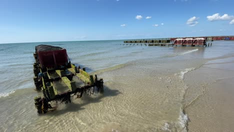 view of the mussel farm and the oyster farm in the sea , shellfish farming in cages by the sandy beach , static