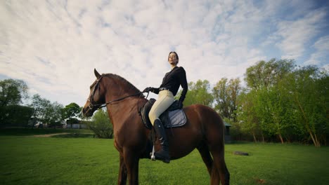 woman horseback riding in a country field
