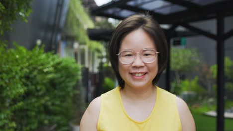 female tourist short hair wearing glasses walking in park using touch smartphone in online shopping and social media to search for travel. women feel relaxed and happy long weekend activities.