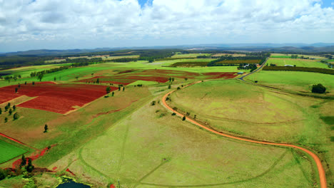 panoramic view on colorful fields in atherton tablelands, queensland, australia on a cloudy day - drone shot