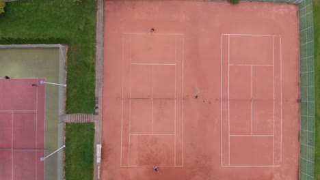 outdoor clay tennis: slow zoom pan, drone overhead