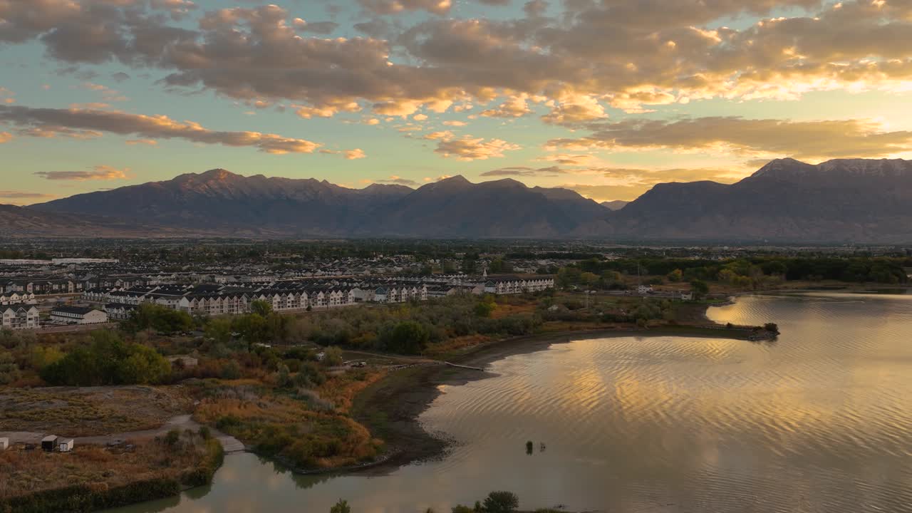 Homes In A Saratoga Springs Neighborhood By Utah Lake And the Wasatch Mountains At Sunrise, Aerial Flyover